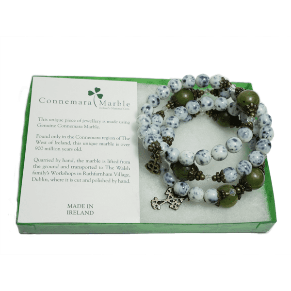 Combining natural beauty with spiritual strength this coiled rosary bracelet comprises of glass beads with pater Connemara Marble beads.