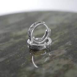 Trinity Knot sterling silver, huggie style earrings. Hand crafted in Ireland with hallmarked 925 silver designed for a comfortable and secure fit.