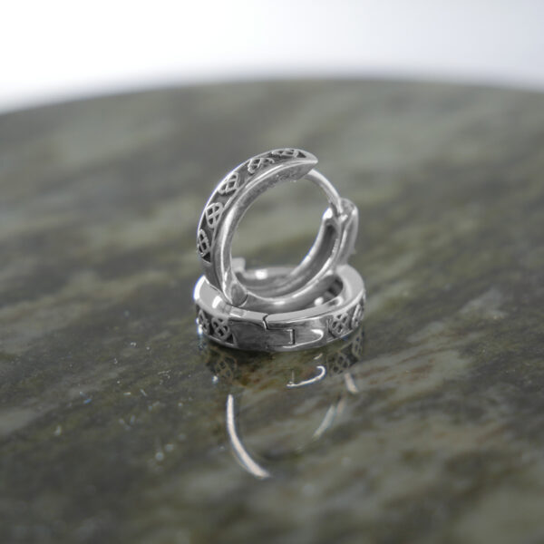 Trinity Knot sterling silver, huggie style earrings. Hand crafted in Ireland with hallmarked 925 silver designed for a comfortable and secure fit.