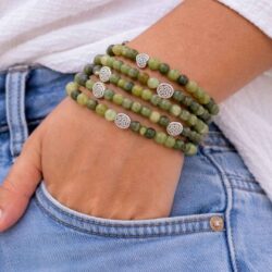 Genuine Connemara marble 5-piece stretch bracelet set with Celtic knot and heart details. Includes pouch and certificate of authenticity. Made in Ireland.