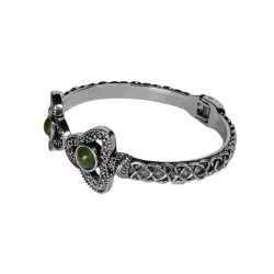 Inspired by the Trinity Knot, this striking Cuff Bracelet symbolizes never ending love. Hand crafted in Ireland with Connemara Marble gemstone.